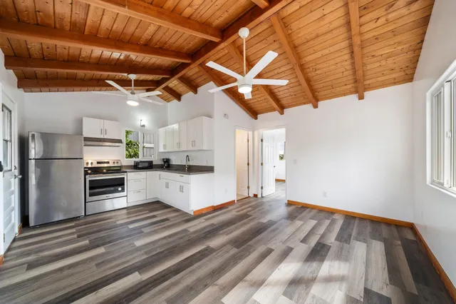 a kitchen with stainless steel appliances granite countertop a refrigerator and a stove