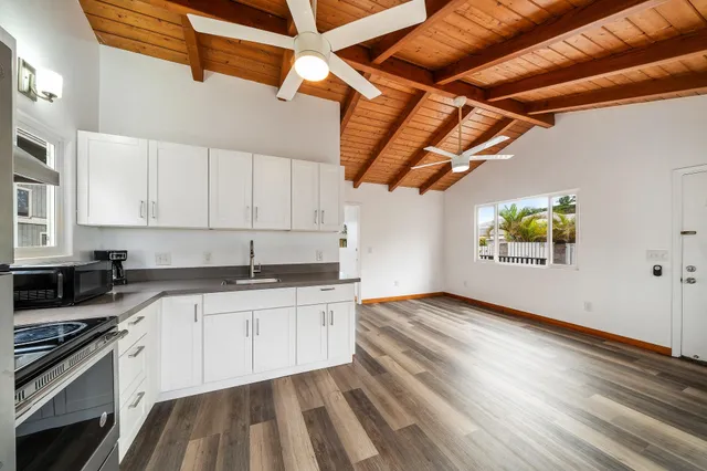 a kitchen with granite countertop a sink stainless steel appliances and cabinets