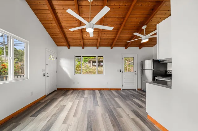 a view of empty room with wooden floor