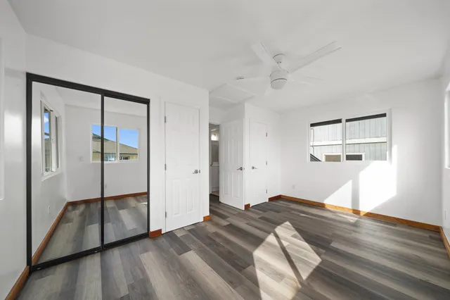 a bedroom with a bed and a mirror