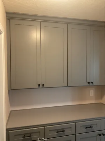 a view of a livingroom with a fireplace a ceiling fan and wooden floor