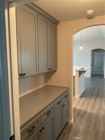 a kitchen with stainless steel appliances a sink dishwasher a stove a refrigerator and white cabinets