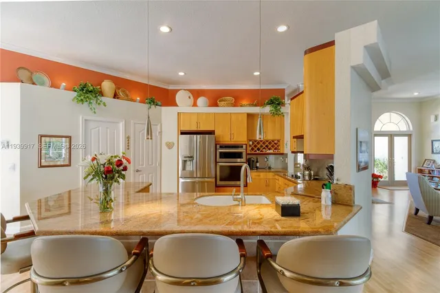 a bathroom with a granite countertop sink a toilet and a mirror