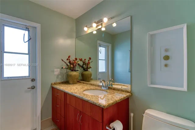 a bathroom with a tub a double vanity sink and a large mirror