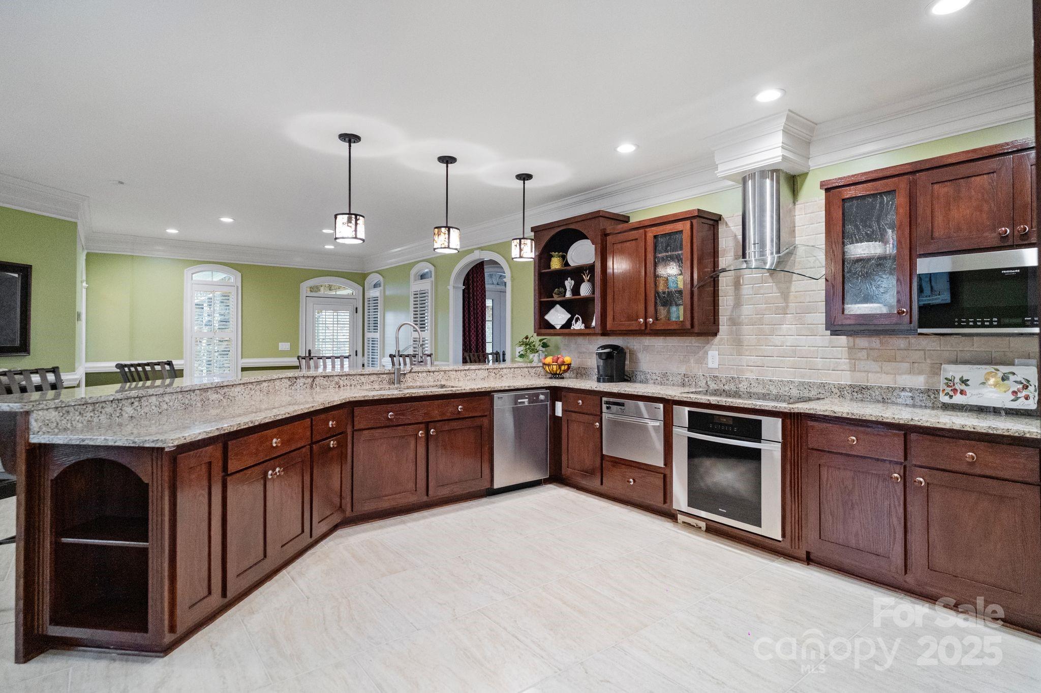 265 Philip Henderson Road Rutherfordton, NC 28139 - Photo 12 of 40 a large kitchen with stainless steel appliances granite countertop a sink and a stove