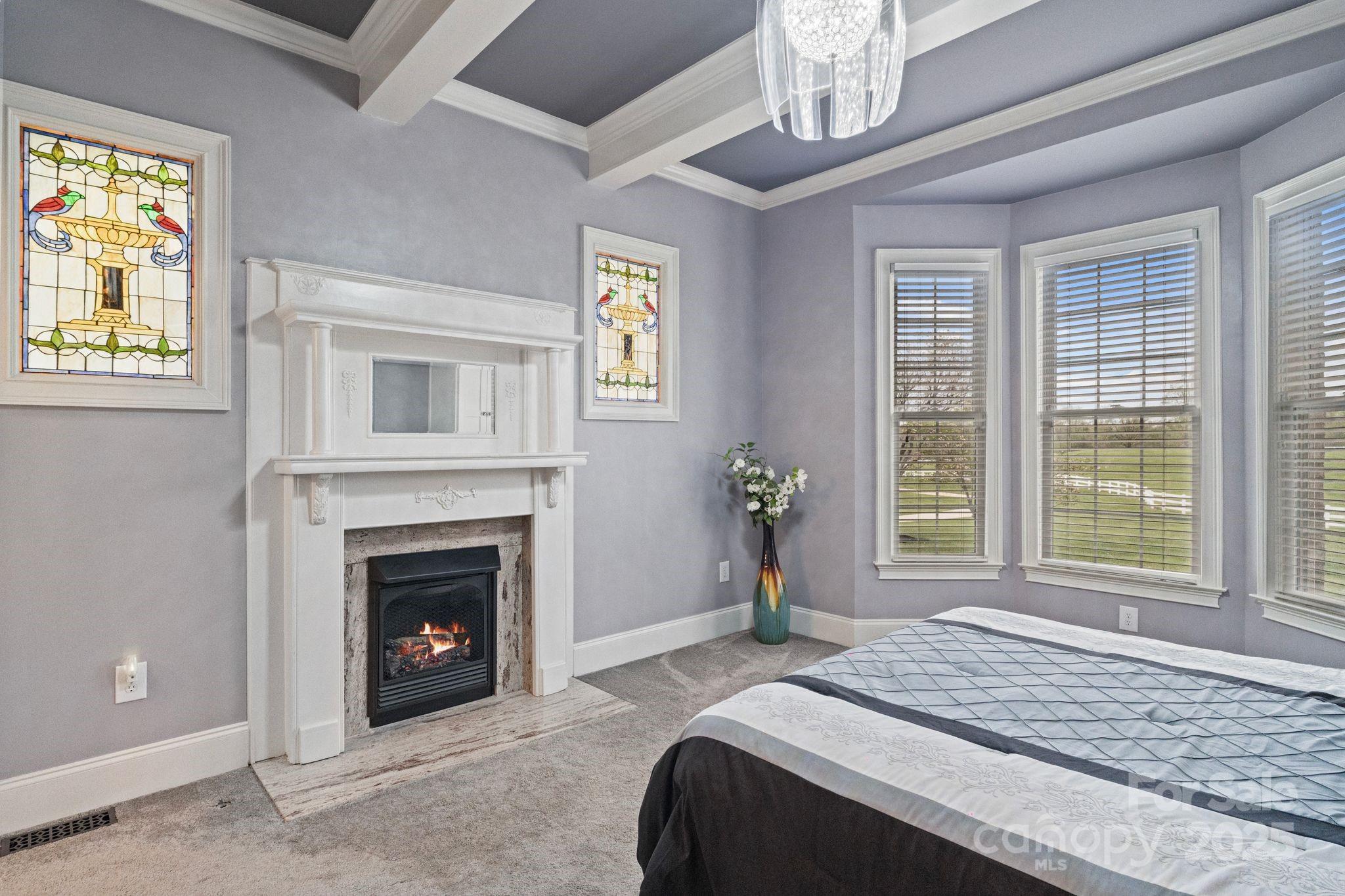 265 Philip Henderson Road Rutherfordton, NC 28139 - Photo 14 of 40 a spacious bedroom with a balcony a bed and a fireplace