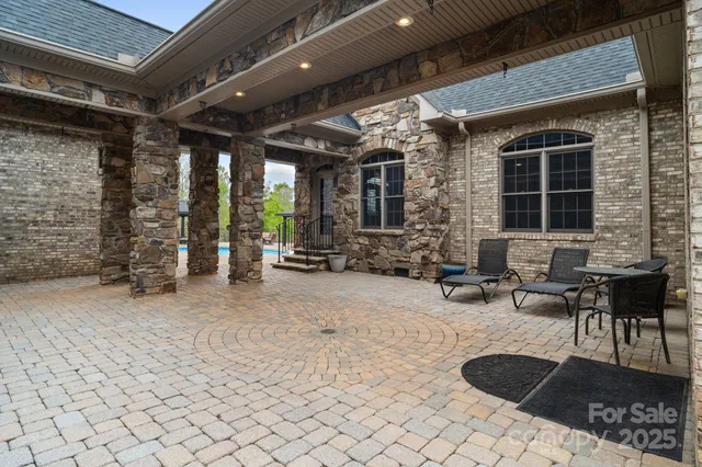 a living room with furniture a fireplace and a dining table with wooden floor
