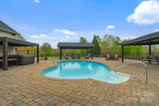 a roof deck with table and chairs a barbeque with potted plants