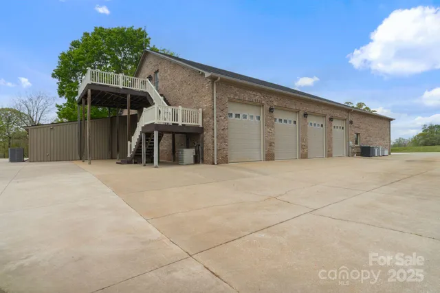 a bedroom with a bed and a view of living room