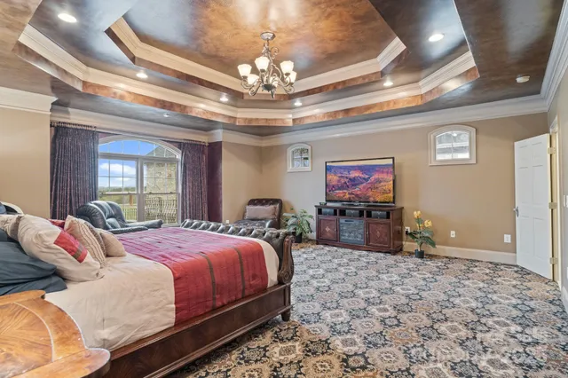 a bedroom with a bed and a chandelier