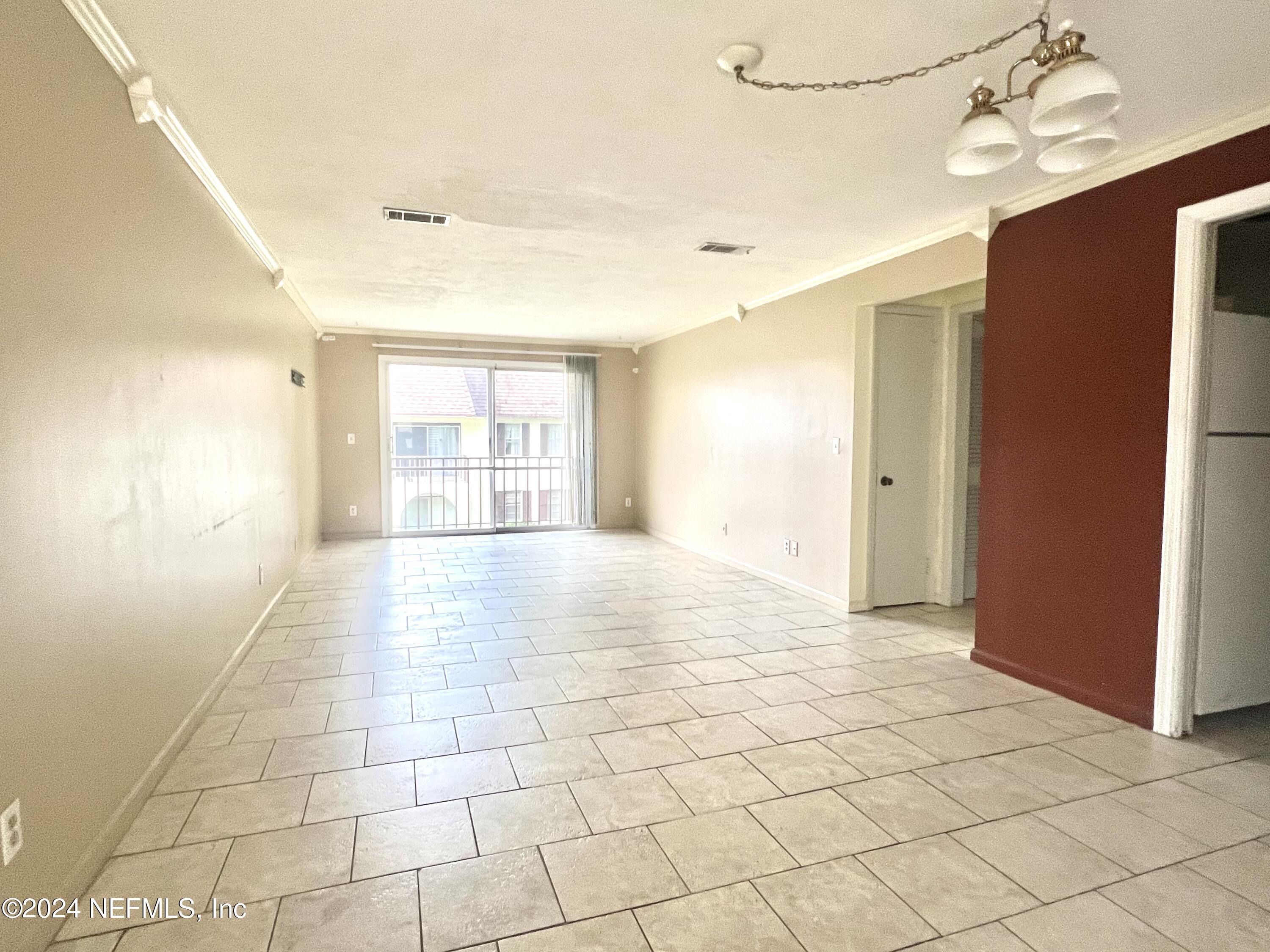 a view of an empty room with a window
