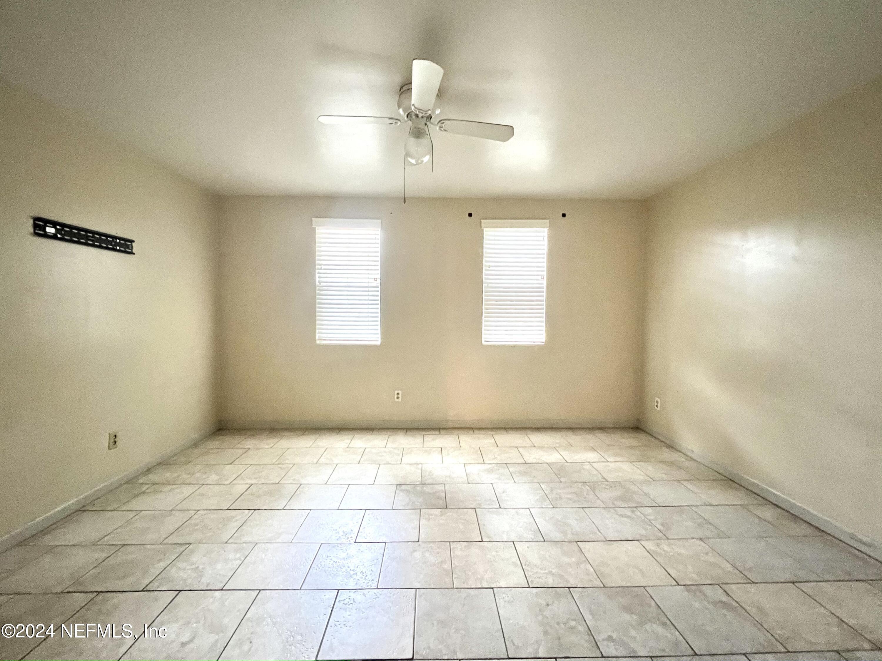 1631 El Prado Road, Unit 4 Jacksonville, FL 32216 - Photo 13 of 23 en empty room with windows and chandelier fan