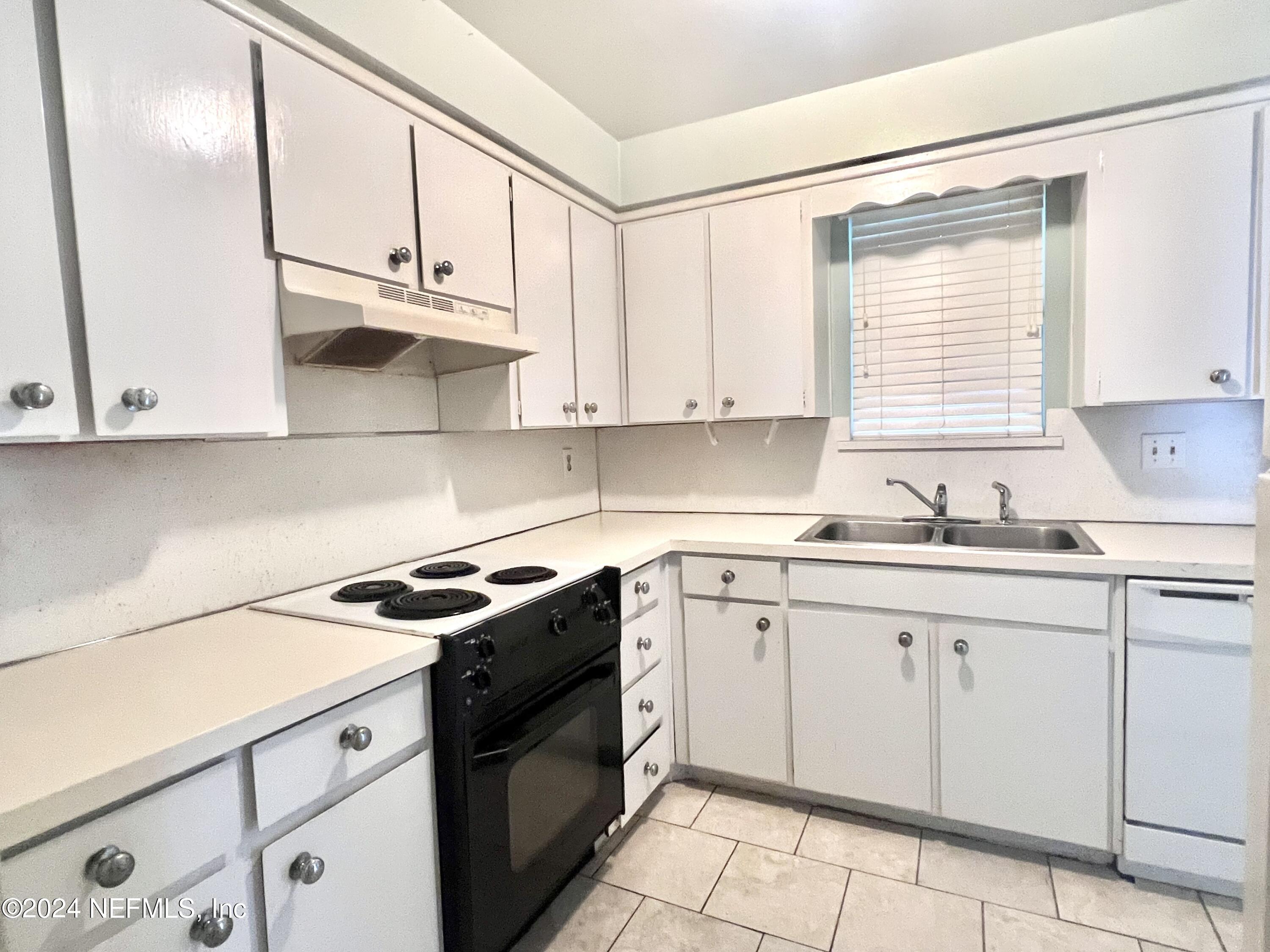 1631 El Prado Road, Unit 4 Jacksonville, FL 32216 - Photo 6 of 23 a kitchen with cabinets appliances a sink and a window