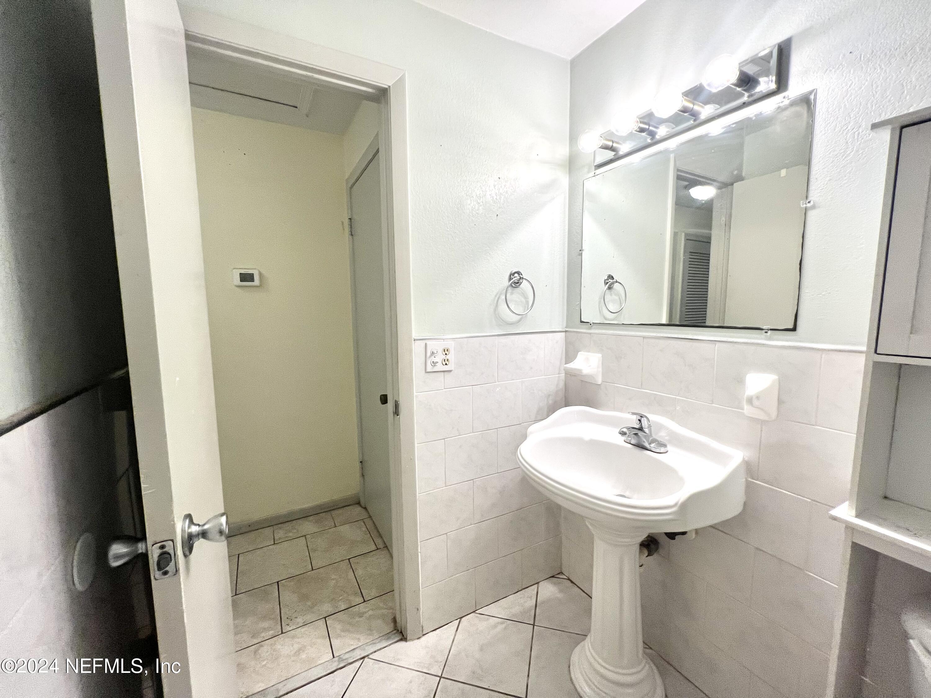 1631 El Prado Road, Unit 4 Jacksonville, FL 32216 - Photo 9 of 23 a bathroom with a sink and a mirror