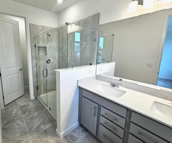 a bedroom with a bed and a lamp