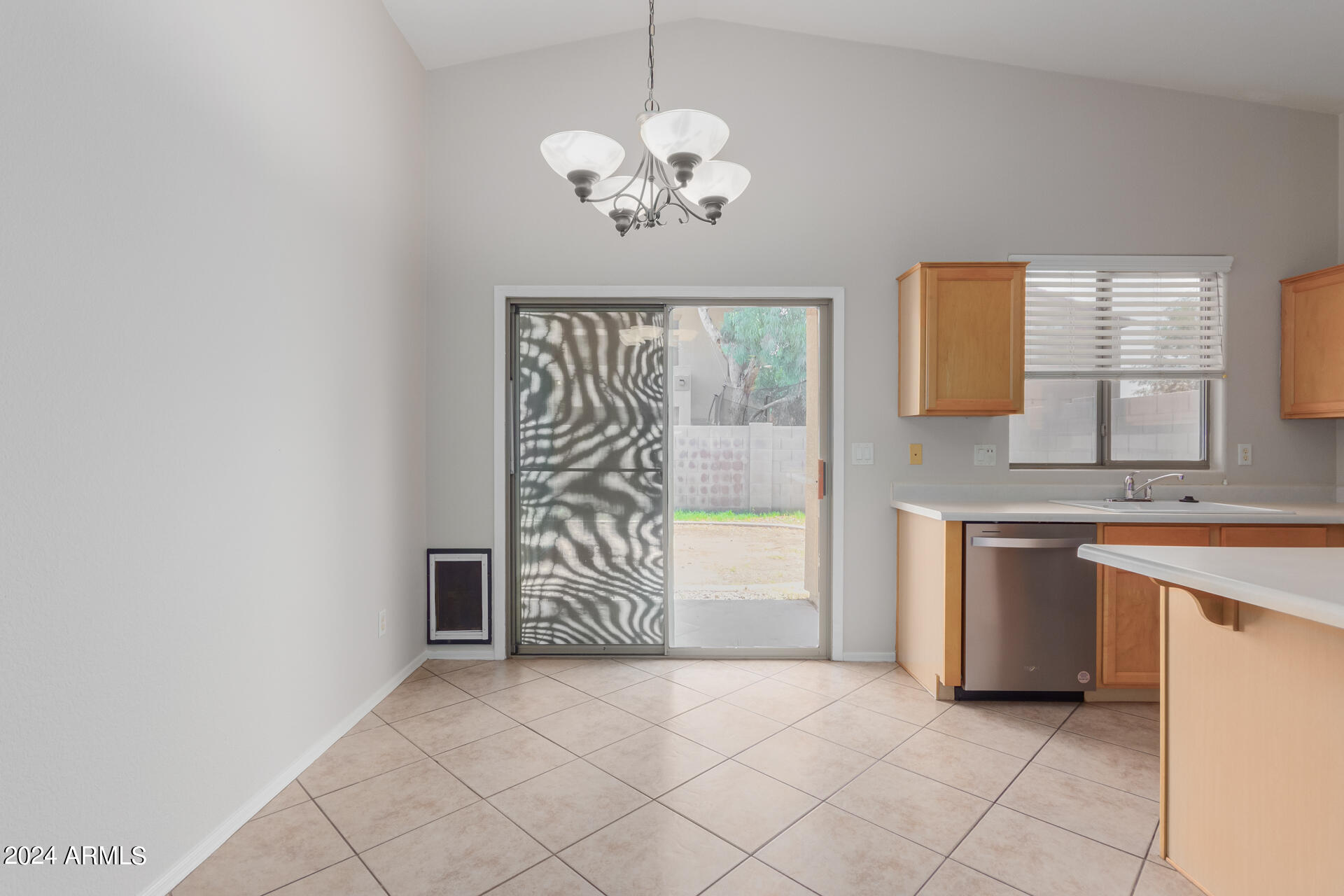 4007 East Ironhorse Road Gilbert, AZ 85297 - Photo 12 of 33 a dining room with chandelier and window