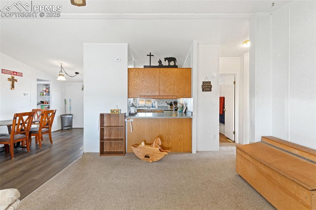 20480 Drennan Road Colorado Springs, CO 80928 - Photo 15 of 47 a view of room with furniture and a chandelier
