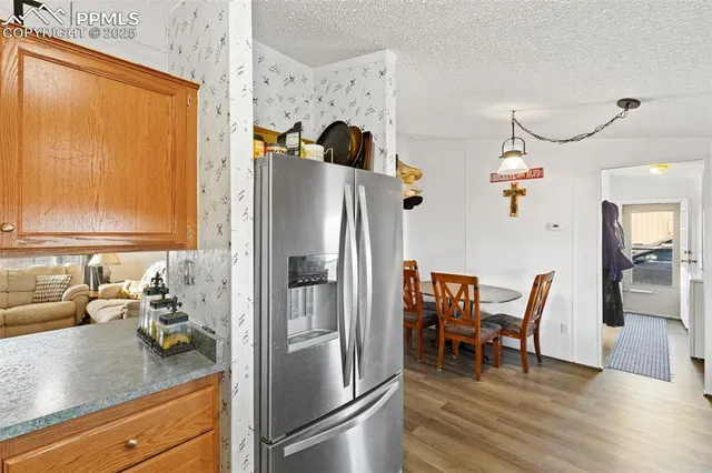 a kitchen with stainless steel appliances granite countertop a refrigerator and a stove top oven