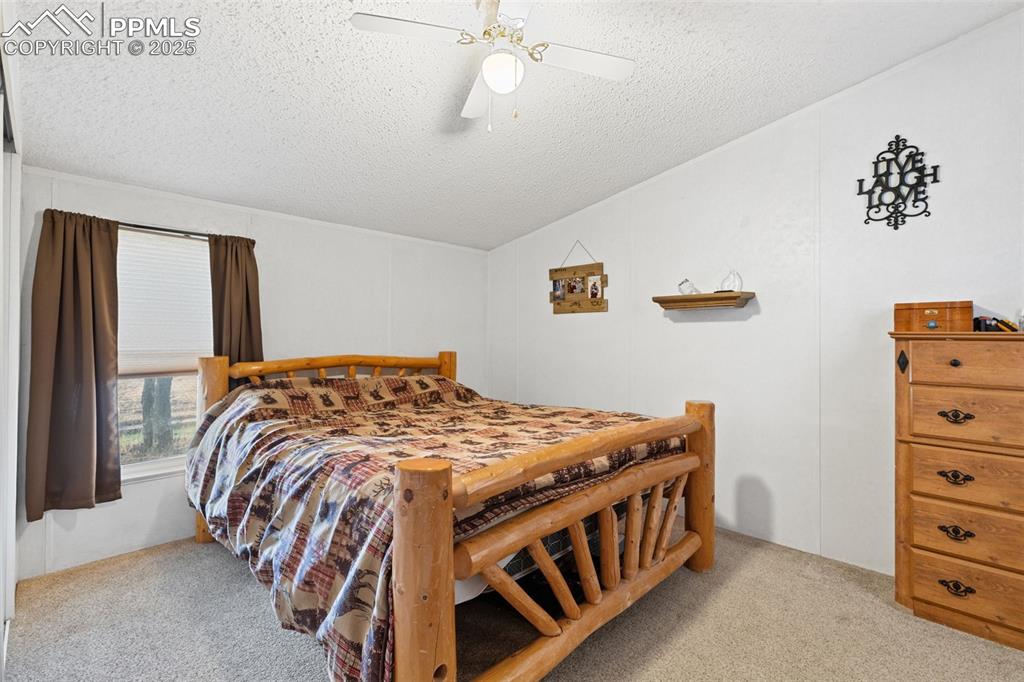 20480 Drennan Road Colorado Springs, CO 80928 - Photo 27 of 47 a bedroom with a bed and a dresser