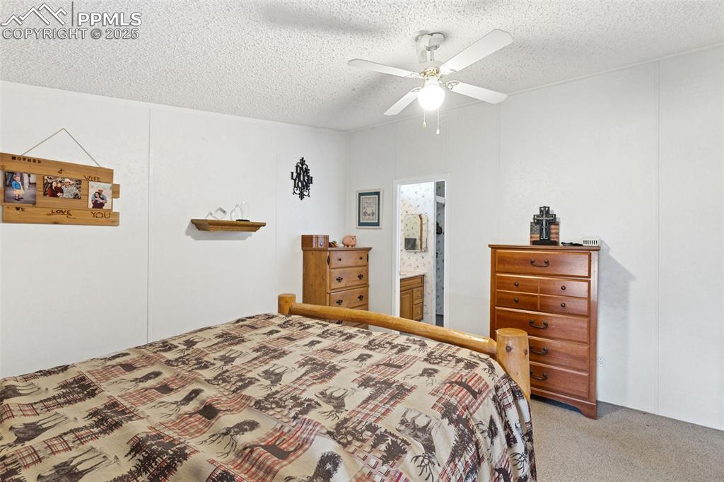 20480 Drennan Road Colorado Springs, CO 80928 - Photo 28 of 47 a bedroom with a bed and a dresser