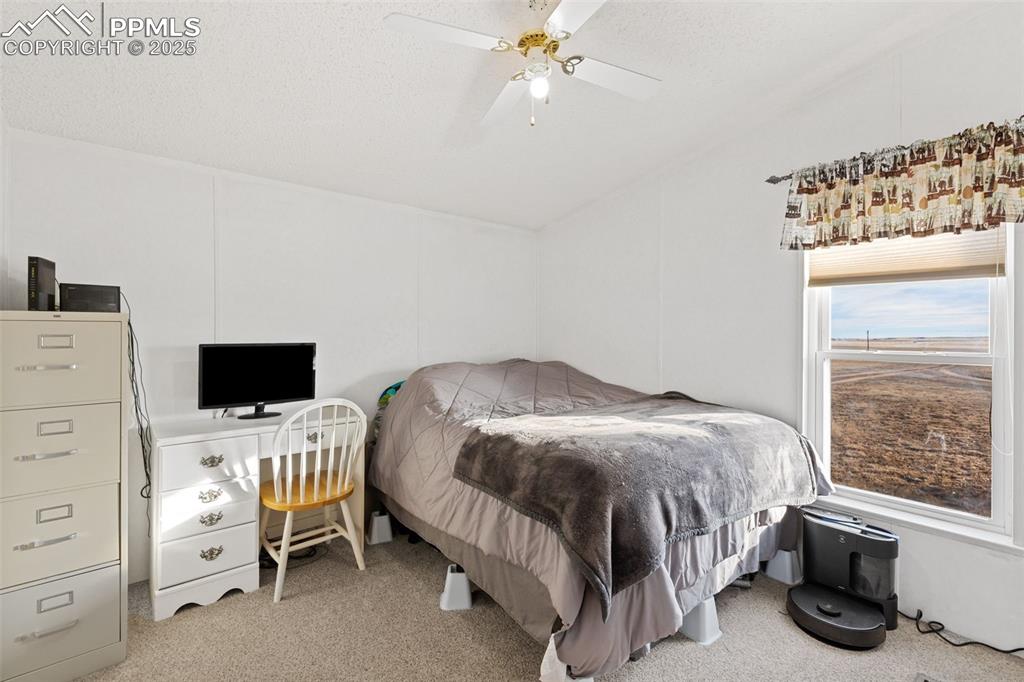20480 Drennan Road Colorado Springs, CO 80928 - Photo 28 of 47 a bedroom with a bed and a window