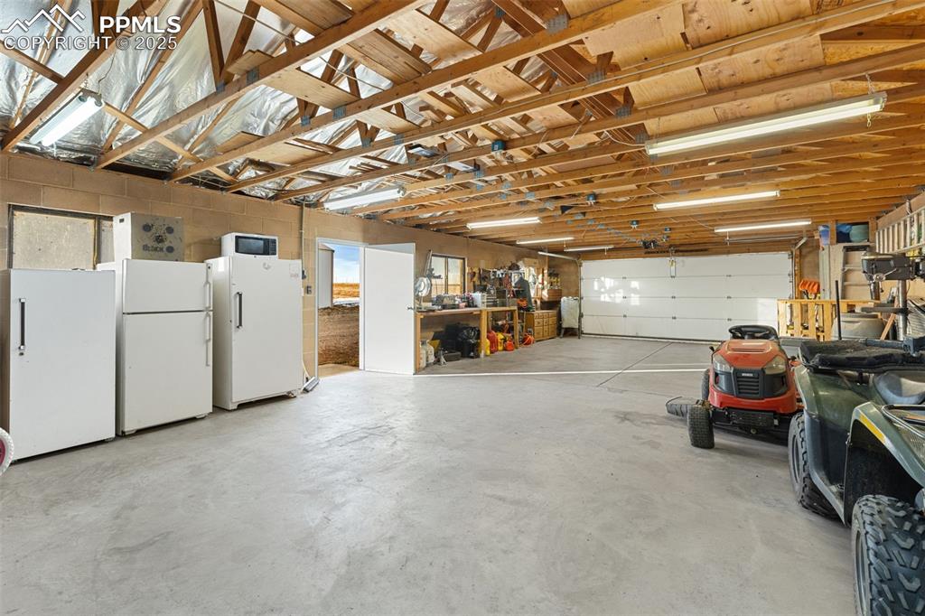 20480 Drennan Road Colorado Springs, CO 80928 - Photo 36 of 47 a view of a garage with parked cars