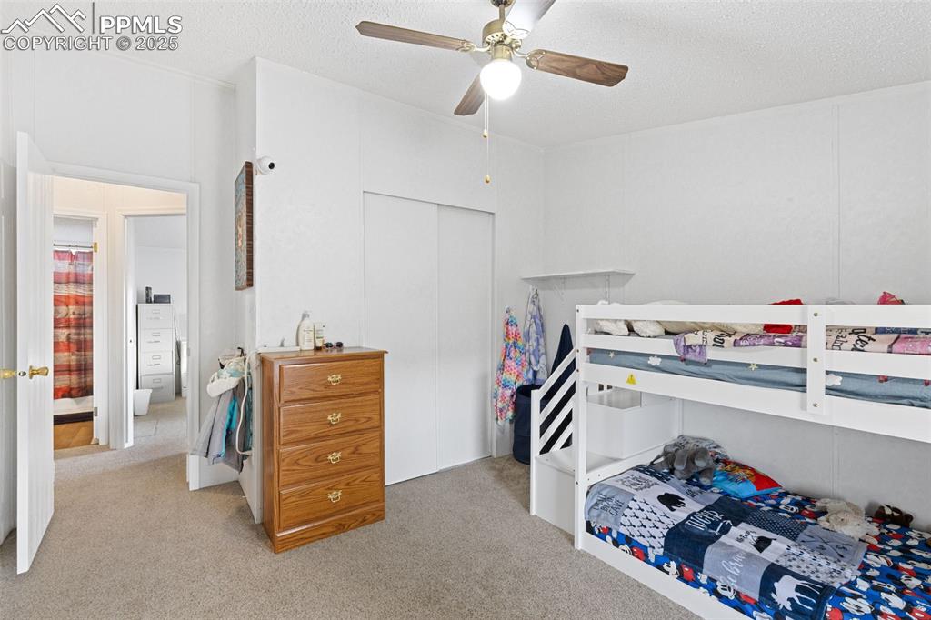 20480 Drennan Road Colorado Springs, CO 80928 - Photo 36 of 47 a bedroom with a bed and a chandelier