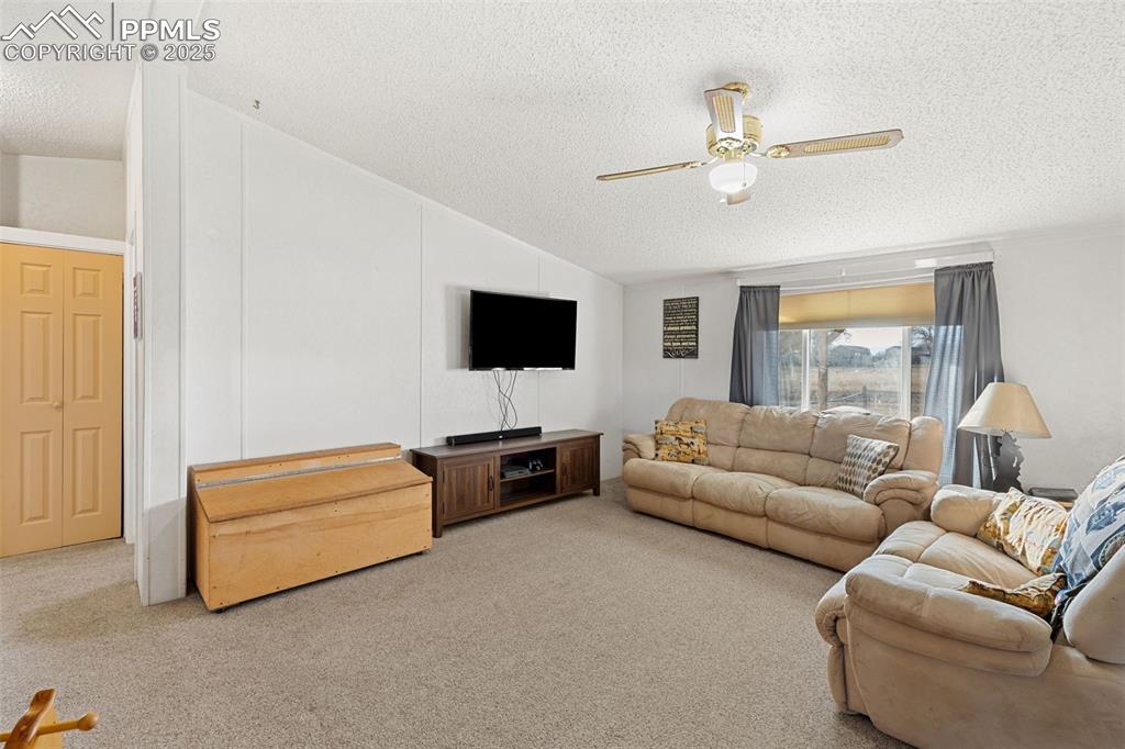 20480 Drennan Road Colorado Springs, CO 80928 - Photo 7 of 47 a living room with furniture and a flat screen tv