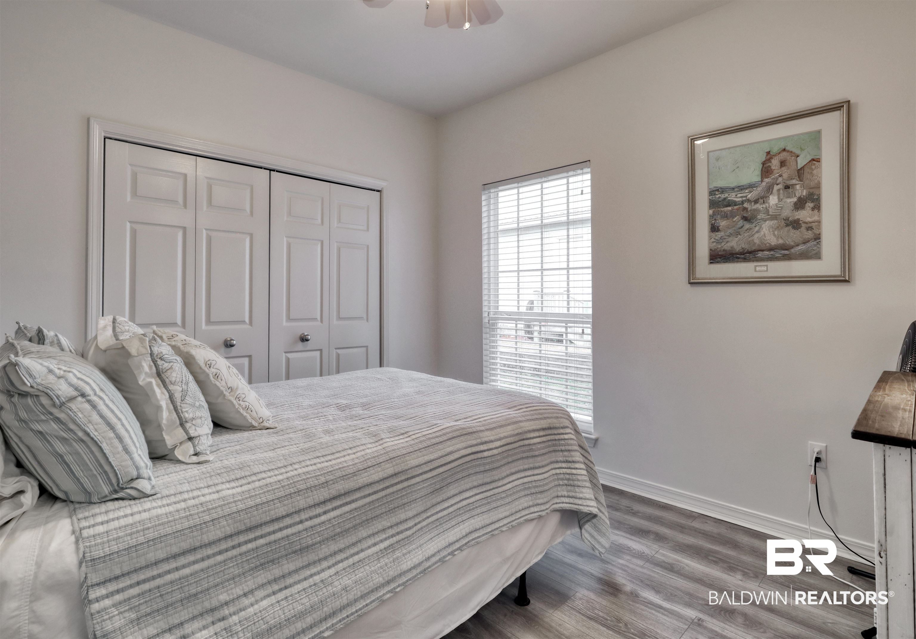 26063 Canal Road, Unit C2 Orange Beach, AL 36561 - Photo 19 of 30 Bedroom featuring wood finished floors and a closet