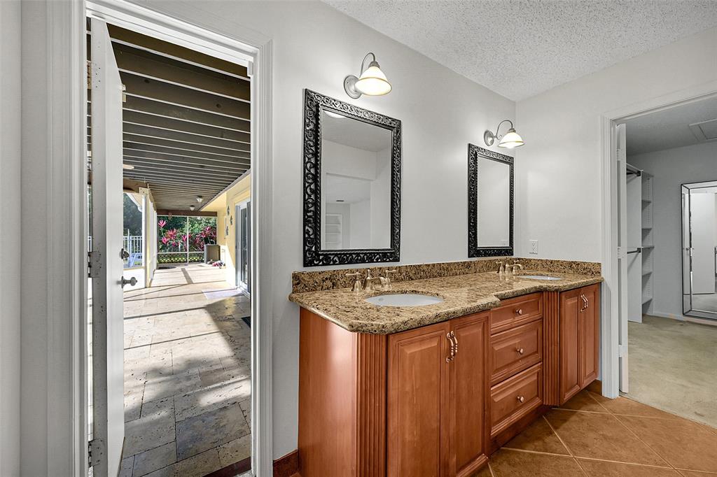 22299 Solitude Drive Boca Raton, FL 33428 - Photo 14 of 31 a bathroom with a granite countertop sink and a mirror