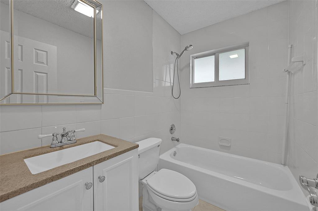 22299 Solitude Drive Boca Raton, FL 33428 - Photo 18 of 31 a bathroom with a sink toilet and bathtub