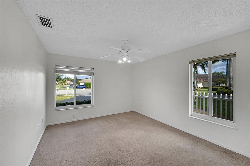 22299 Solitude Drive Boca Raton, FL 33428 - Photo 19 of 31 an empty room with windows and entrance