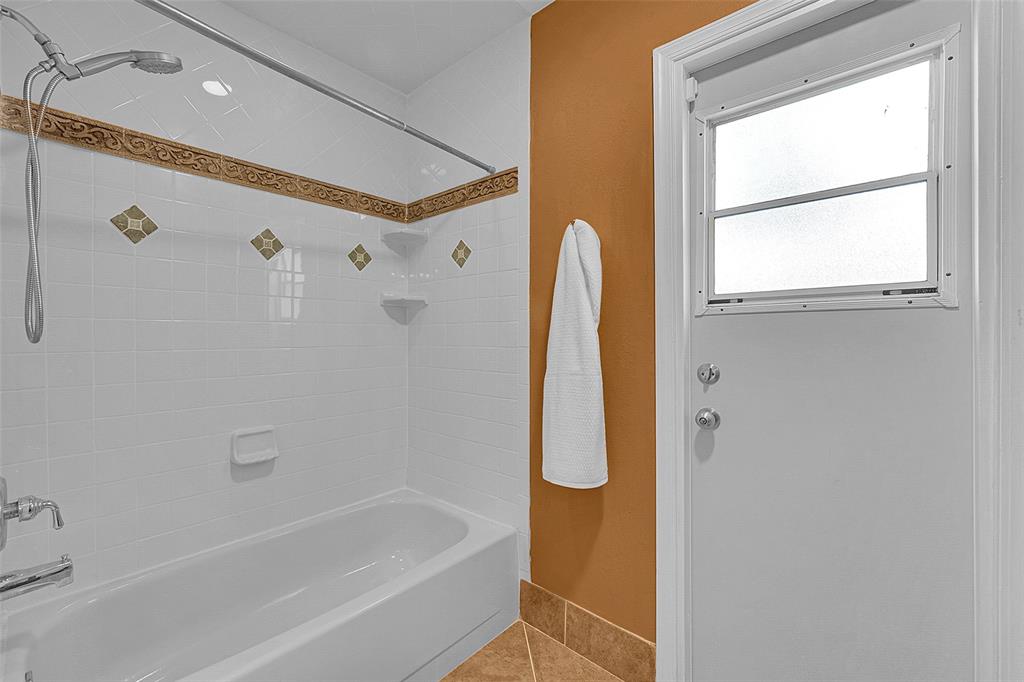 22299 Solitude Drive Boca Raton, FL 33428 - Photo 22 of 31 a bathroom with a bathtub a window and a shower