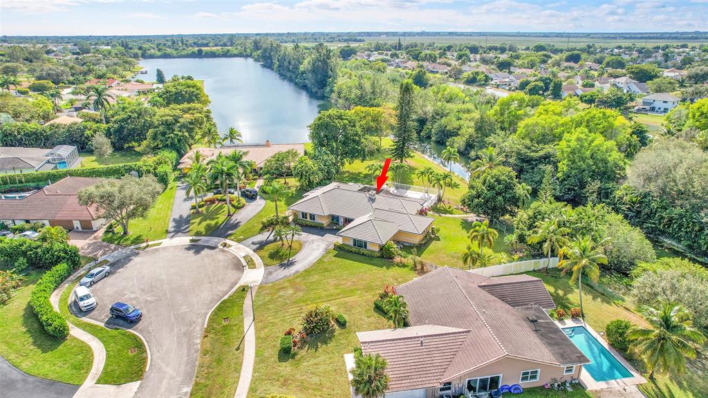 22299 Solitude Drive Boca Raton, FL 33428 - Photo 3 of 31 an aerial view of a house with a yard and lake view