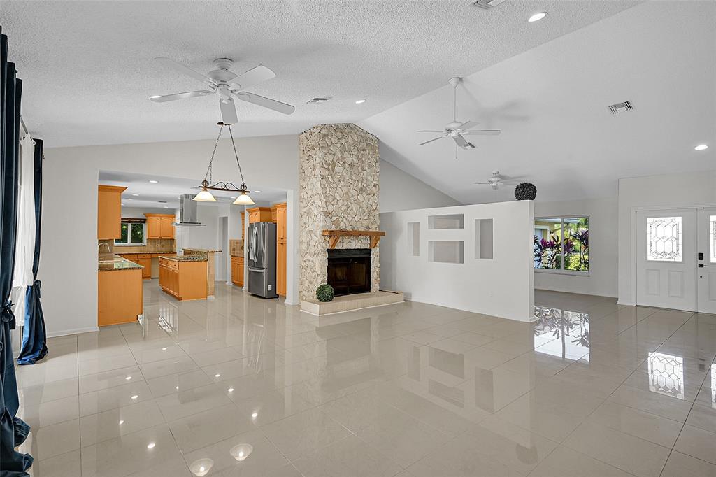 22299 Solitude Drive Boca Raton, FL 33428 - Photo 7 of 31 an empty room with fireplace and windows