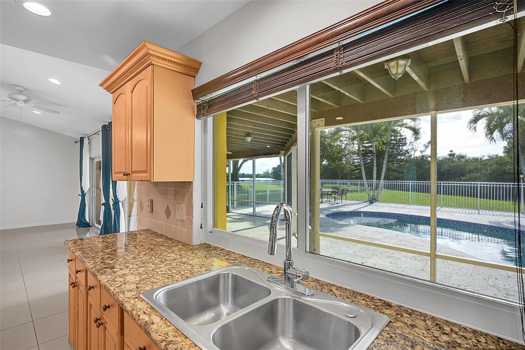 22299 Solitude Drive Boca Raton, FL 33428 - Photo 10 of 31 a kitchen with a sink and a large window