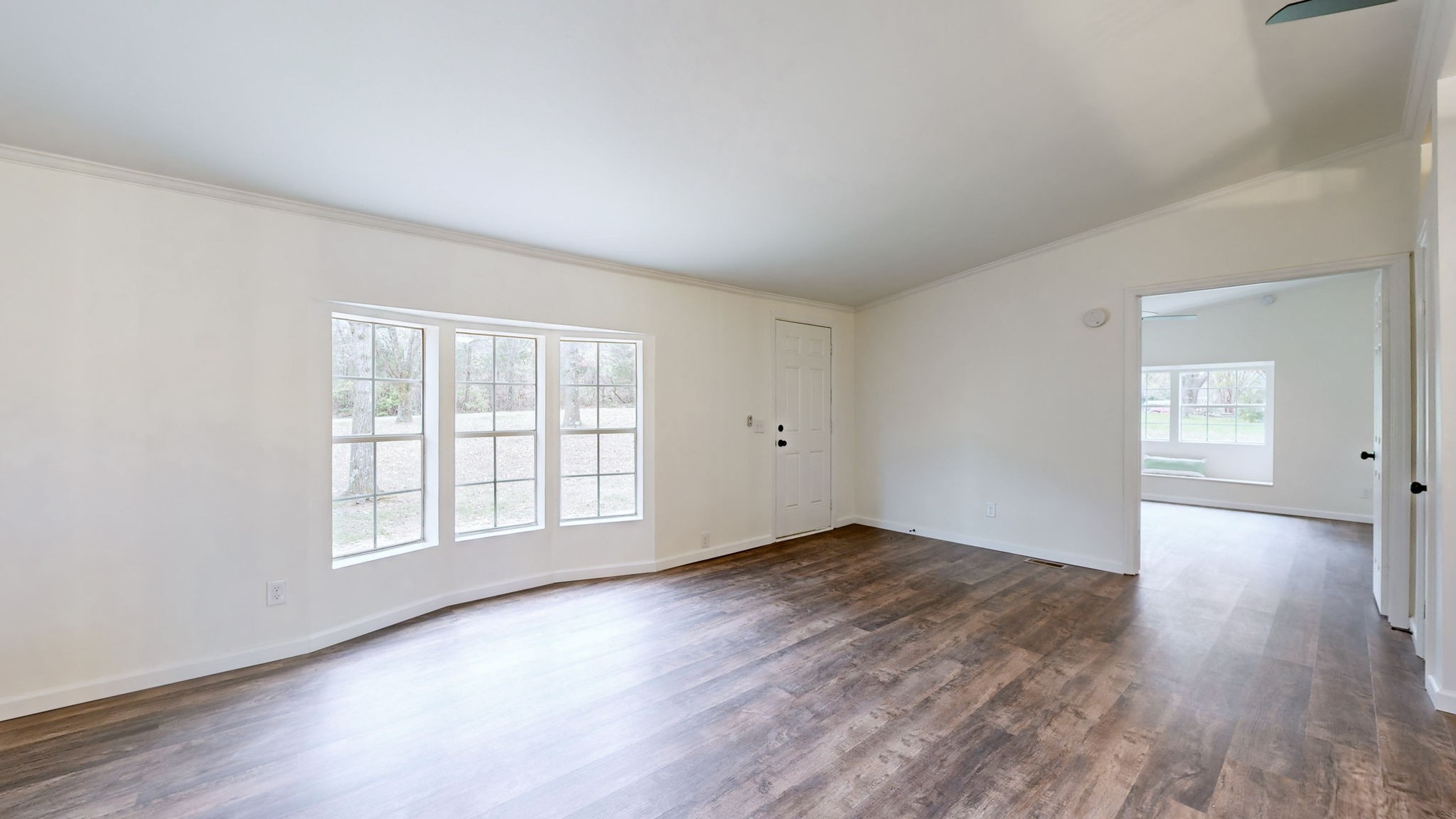 4452 William Woodard Road Springfield, TN 37172 - Photo 11 of 45 an empty room with wooden floor and windows