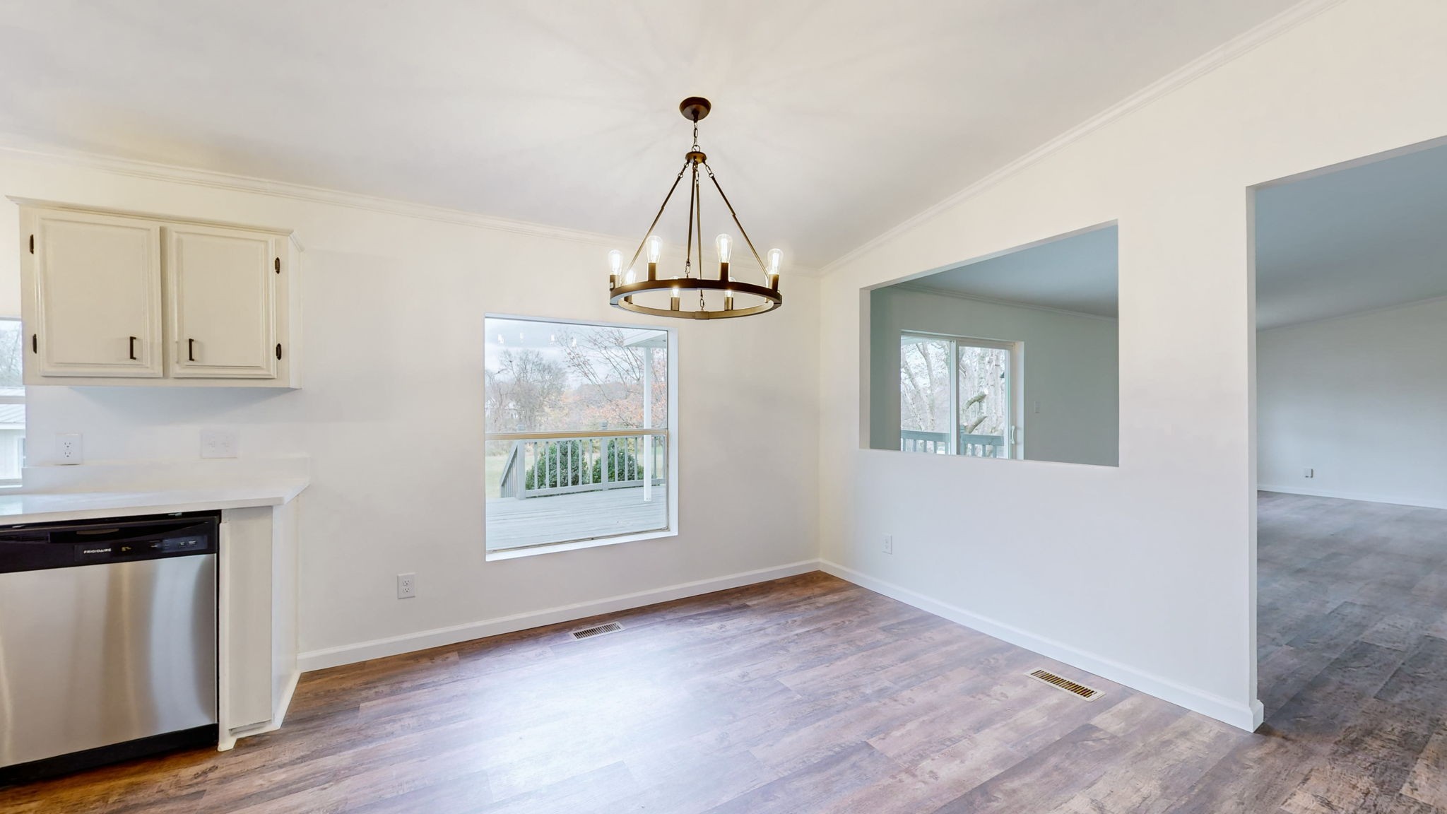 4452 William Woodard Road Springfield, TN 37172 - Photo 17 of 45 a hallway with a chandelier and wooden floor