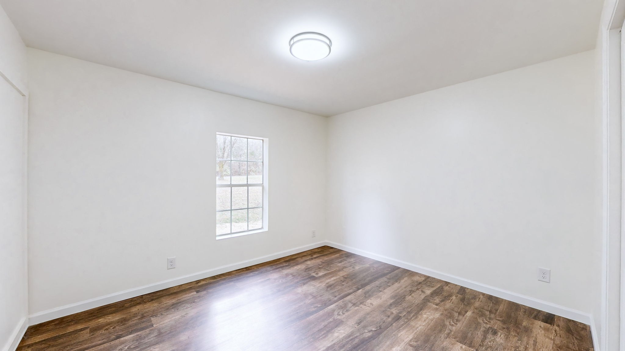 4452 William Woodard Road Springfield, TN 37172 - Photo 30 of 45 an empty room with wooden floor and windows