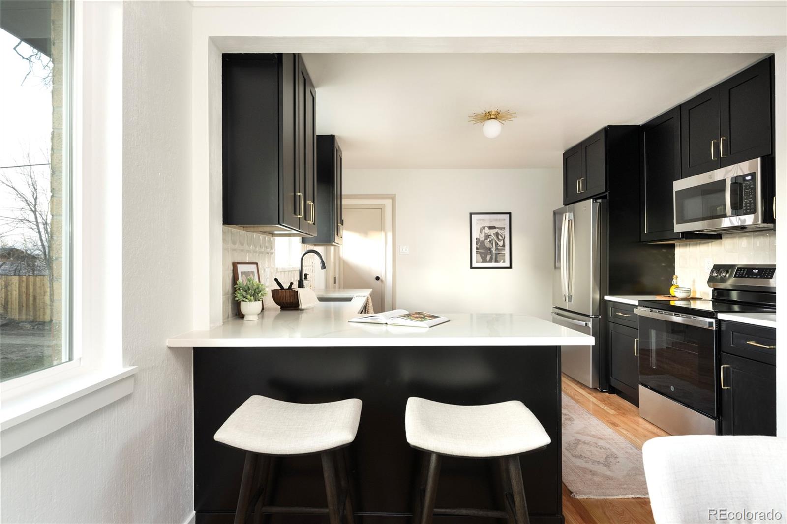 1617 Wolff Street Denver, CO 80204 - Photo 17 of 38 a kitchen with stainless steel appliances a sink stove and refrigerator