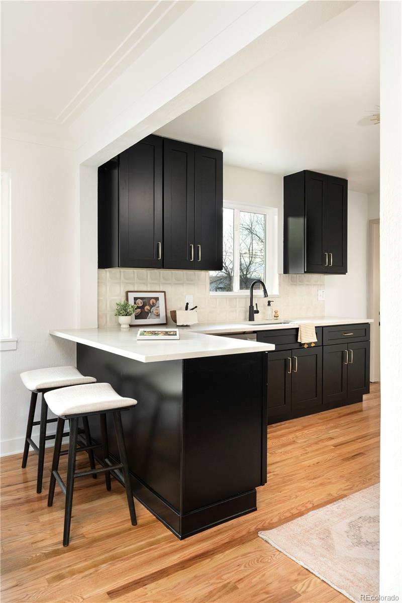 1617 Wolff Street Denver, CO 80204 - Photo 18 of 38 a kitchen with a sink cabinets and wooden floor