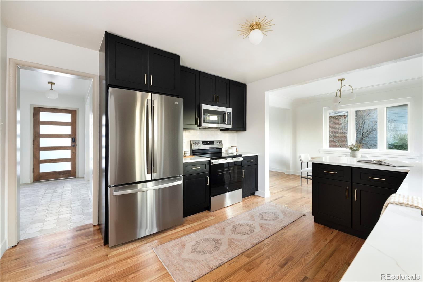 1617 Wolff Street Denver, CO 80204 - Photo 19 of 38 a kitchen with a refrigerator cabinets and wooden floor