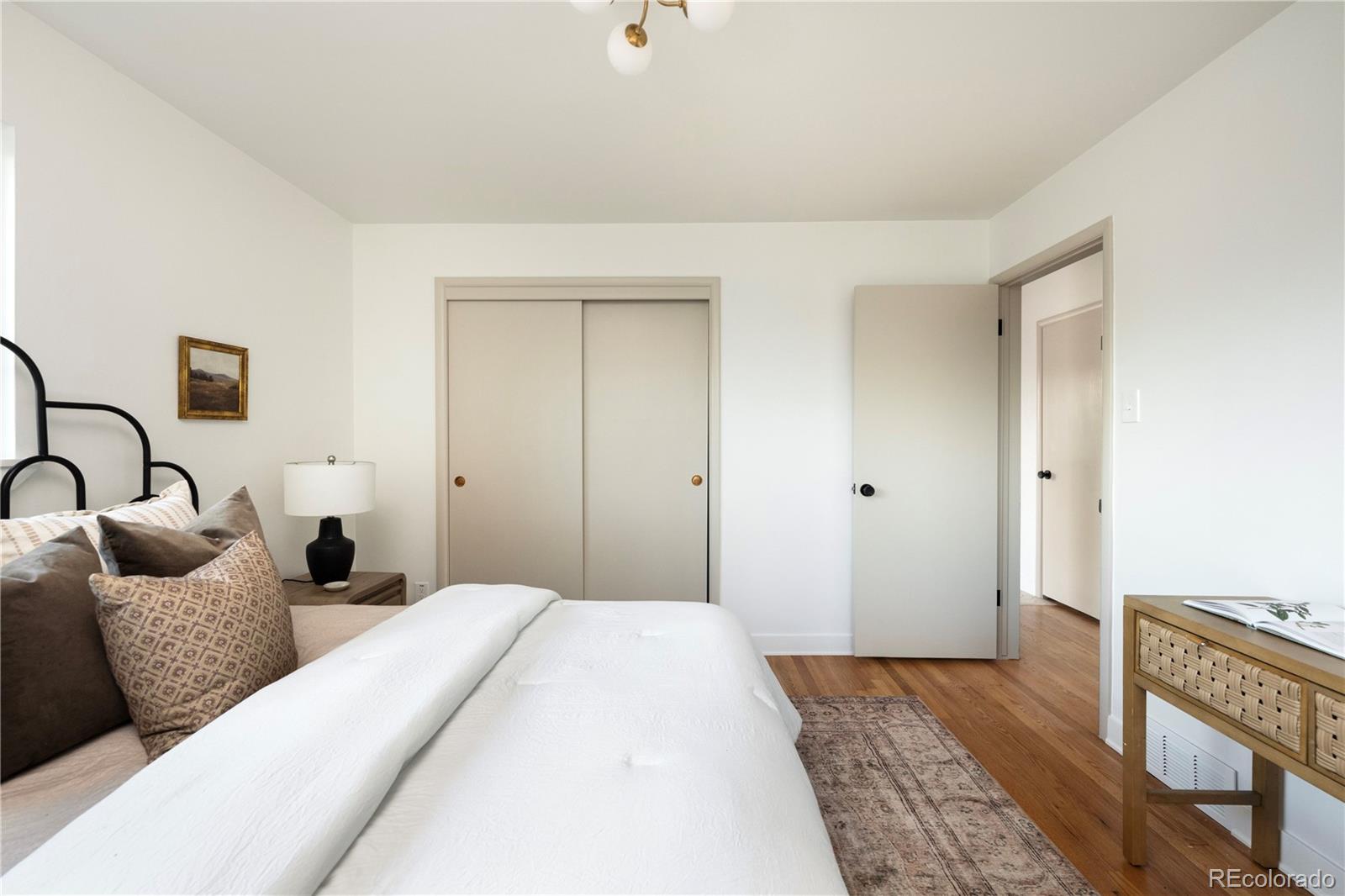 1617 Wolff Street Denver, CO 80204 - Photo 22 of 38 a bedroom with bed and walk in closet