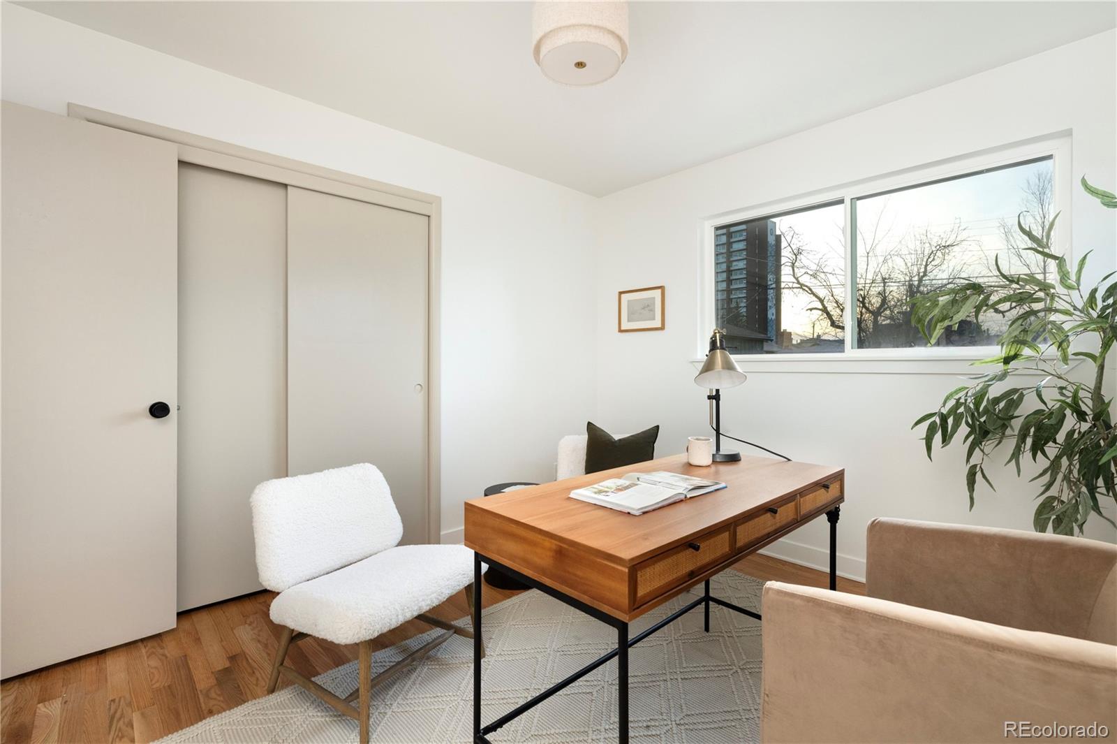 1617 Wolff Street Denver, CO 80204 - Photo 24 of 38 a workspace with furniture and a potted plant