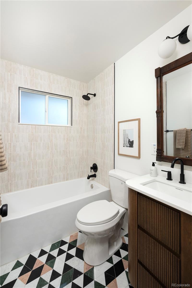 1617 Wolff Street Denver, CO 80204 - Photo 25 of 38 a bathroom with a sink a toilet and shower