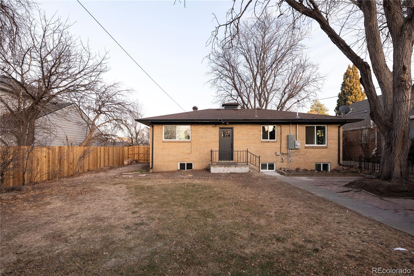 1617 Wolff Street Denver, CO 80204 - Photo 35 of 38 a view of a house with a big yard and large tree