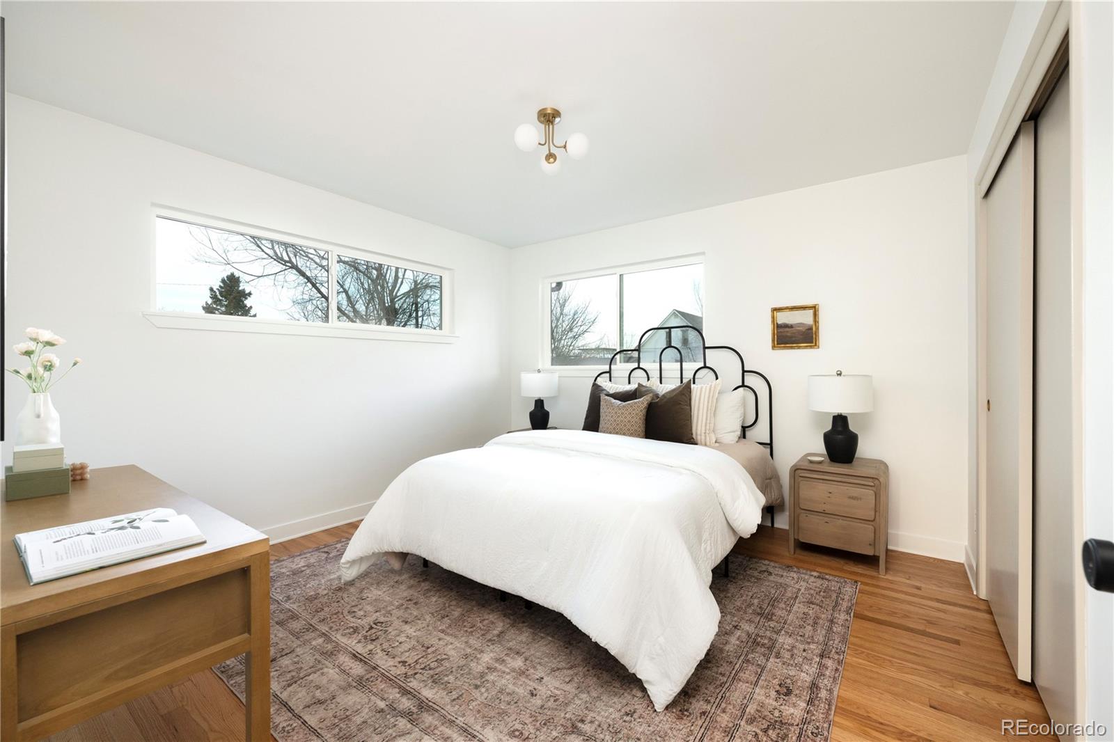 1617 Wolff Street Denver, CO 80204 - Photo 7 of 38 a bedroom with a bed and wooden floor