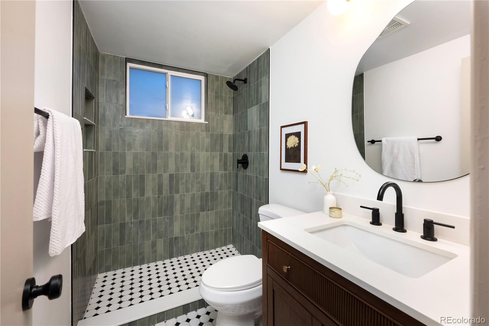 1617 Wolff Street Denver, CO 80204 - Photo 8 of 38 a bathroom with a sink a toilet and shower