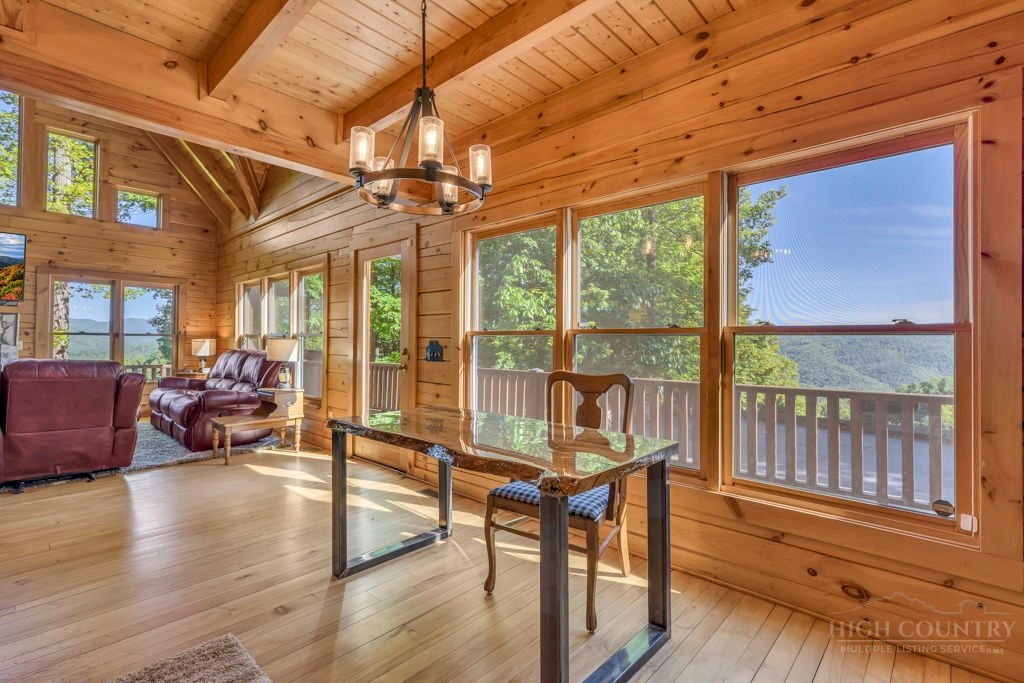 2229 Elk Ridge Road Ferguson, NC 28624 - Photo 12 of 42 a living room with furniture floor to ceiling windows and wooden floor