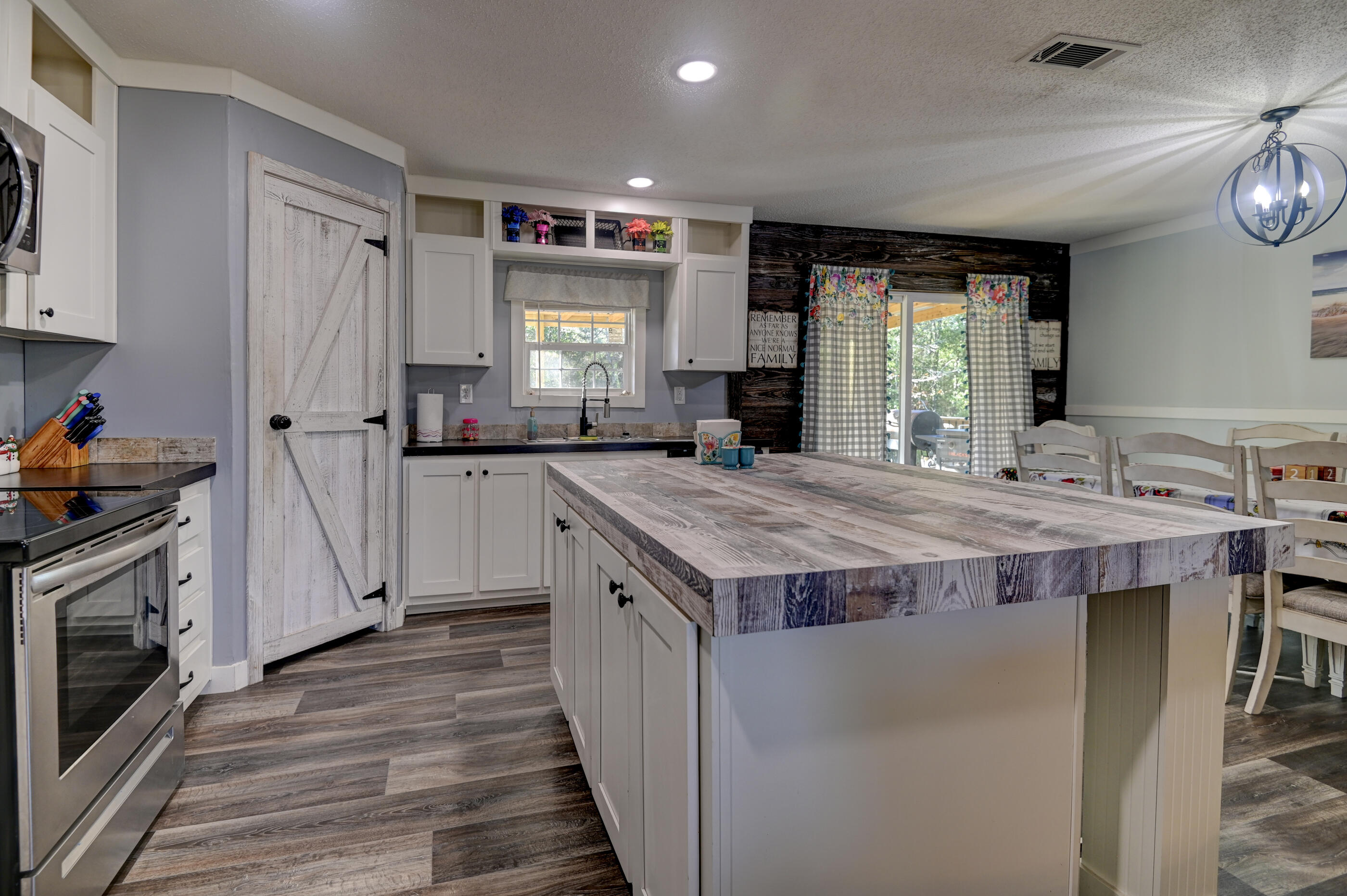 5256 Mt Olive Road Crestview, FL 32539 - Photo 14 of 68 a kitchen with stainless steel appliances granite countertop a stove and a sink